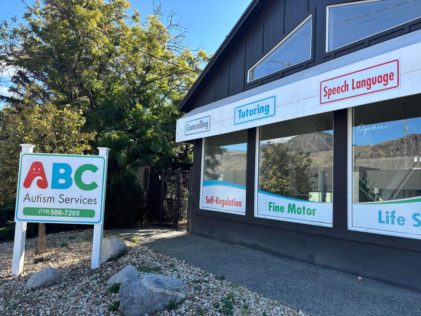 The ABC Autism Services sign beside the dark building on Seymour Street, with window lettering for counselling, tutoring and speech language